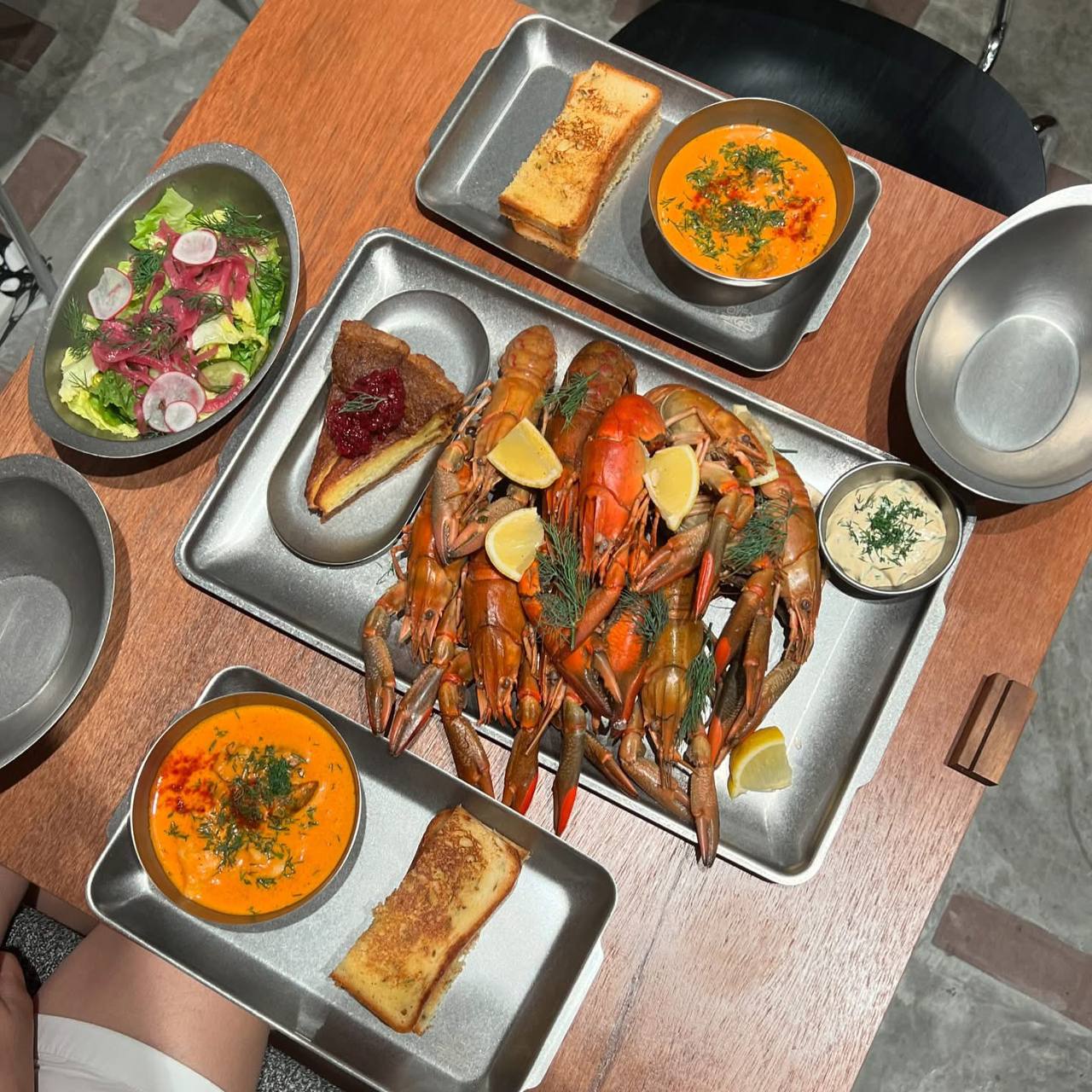 Seafood platter with crayfish, soup, and salad